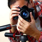 Photographer in red plaid shirt behind the camera taking pics for Ortley Beach real estate homes