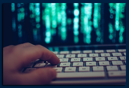 Web Design Toms River, Close-up of hand on keyboard in front of screen with green graphic