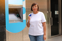 Happy ATM user at machine serviced by top NJ NCR company