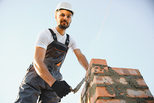 Baron's Chimney Service professional at work on masonry of a chimney