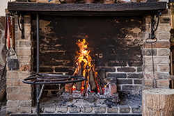Heavy creosote shown in a fireplace in need of Hazlet fireplace service.